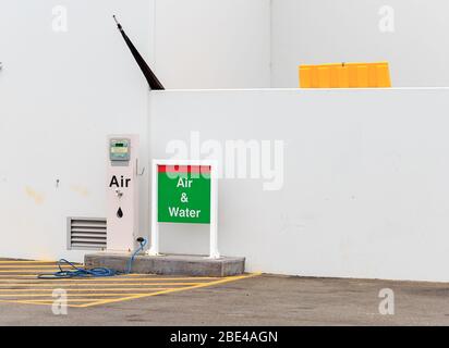 Air pump and water fill equipment at a gas service station with a white wall background Stock Photo