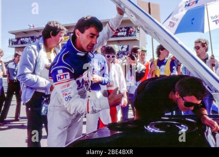 Bathurst, Australia, October 5th, 1986: Legendary Australian motor racing driver Peter Brock inspects the engine of his 05 Mobil Commodore on the grid before the start of the 1986 James Hardie (Bathurst) 1000 race. With his equally famous co-driver Allan Moffat he finished an admirable 5th place after losing a three lap advantage during pit repairs on the 1000km race. Brock and Moffat between them, had won 12 of the 16 previous races at the Bathurst circuit. Stock Photo