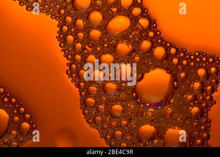 Bubbles and drops close up.  orange  liquid background Stock Photo