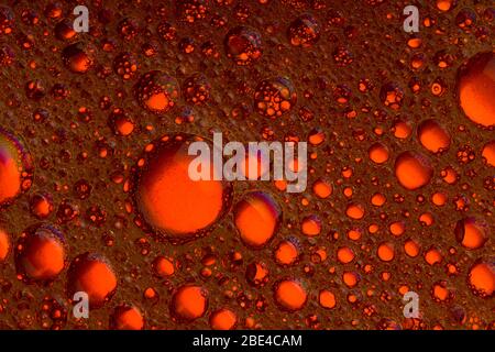 Oil and water dark red and orange bubbles and drops Stock Photo
