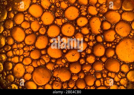 Water Abstract Macro Foam Background. Yellow drops and bubbles of oil. Close up Stock Photo