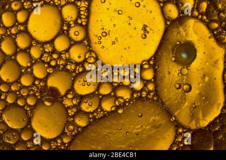 Water Abstract Macro Foam Background. Yellow drops and bubbles of oil. Stock Photo