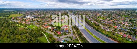 Eastlink highway passing through residential areas in Melbourne, Australia - aerial panorama Stock Photo