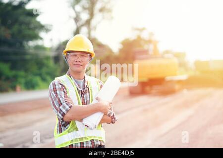 Engineer holding blueprint in construction site Stock Photo