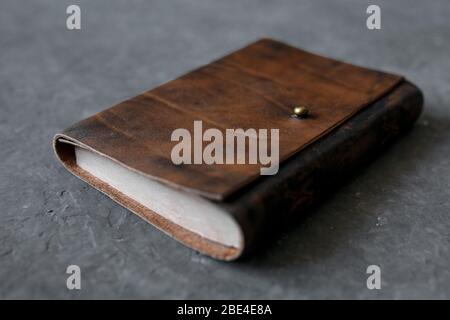 open craft notepad with leather cover l on gray background. Stock Photo