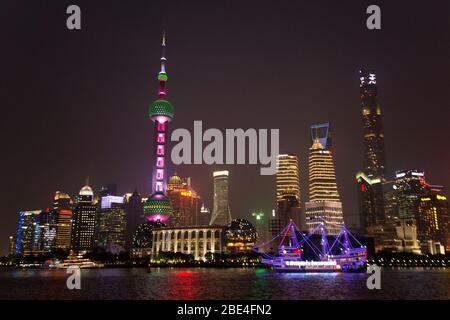 Shanghai's Pudong skyline towers over the Huangpu River, view from The Bund by night. China Stock Photo