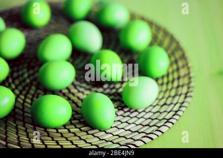 Top view green eggs on the table round wicker Board in the kitchen Stock Photo