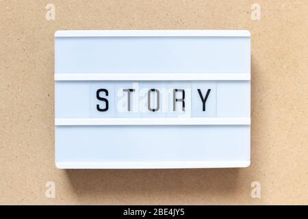White lightbox with word story on wood background Stock Photo