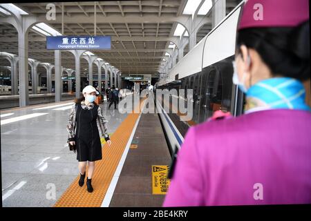 Chongqing, China. 12th Apr, 2020. A passenger prepares to board the first train from Chongqing in the high-speed rail loop that connects southwest China's major cities at Chongqing West Railway Station in southwest China's Chongqing Municipality, April 12, 2020. A high-speed rail loop that connects major cities in China's southwestern region started operation on Friday, according to the local railway operator. The route, extending 1,290 km, connects Chengdu, capital of Sichuan Province, Chongqing Municipality, and Guiyang, capital of Guizhou Province. Credit: Xinhua/Alamy Live News Stock Photo