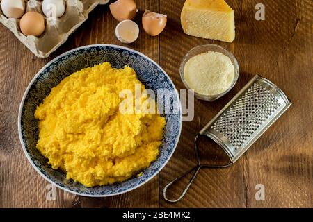 The picture shows the egg and cheese dough, typical traditional Easter filling from Campania used to fill panzerotti on wooden background Stock Photo