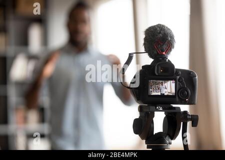 Close up focus on digital camera, showing mixed race man. Stock Photo