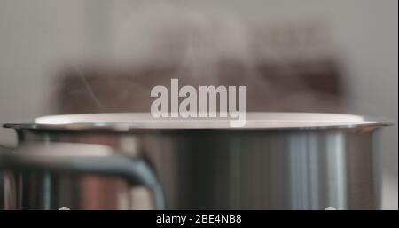 steam rising from pot while cooking Stock Photo