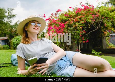 Woman charge smartphone from power bank outdoors Stock Photo
