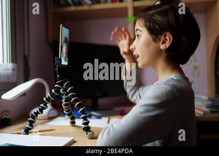 Little girls talking via video conference with smartphone Stock Photo