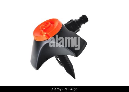 lawn sprinkler black with orange top isolate close-up Stock Photo