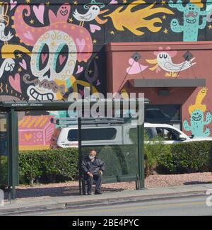 Los Angeles, USA. 12th Apr, 2020. An elderly man wears a mask as he waits for a bus in Los Angeles on Saturday, April 11, 2020. State and local policies ordered residents to shelter-in-place until at least May 15th in the wake of the coronavirus pandemic. Photo by Jim Ruymen/UPI Credit: UPI/Alamy Live News Stock Photo