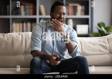 Young biracial man worrying about bad results of sport team. Stock Photo