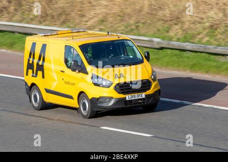 2019 Ford Transit Custom 340 Base; Yellow AA Van 24hr breakdown recovery truck. Side view of rescue breakdown recovery vehicle transporter driving along  M6 motorway,  Preston UK; Vehicular traffic, transport, modern van on the 3 lane highway. Stock Photo