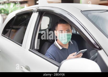 young handsome male using mobile phone while driving his car Stock Photo