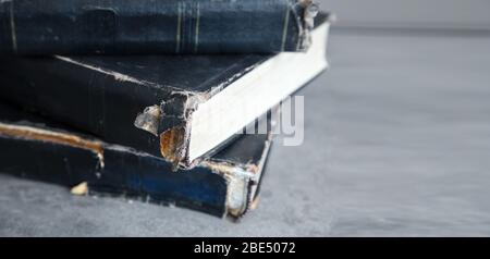 three old shabby books lying on the table indoor closeup Stock Photo
