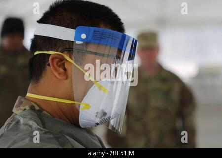 RHODE ISLAND, USA - 30 March 2020 - Soldiers from the Rhode Island US National Guard began setting up a testing station at Community College of Rhode Stock Photo