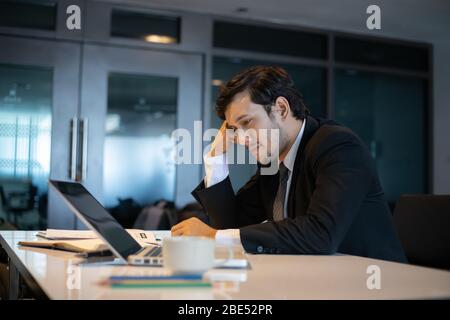 Asian businessmen using notebook for working and businessman serious about the work done until the headache Stock Photo