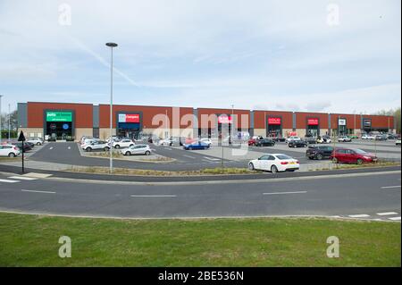 Cumbernauld, UK. 12th Apr, 2019. Pictured: Overview scene of the retail park, showing how busy it is during a lockdown. Scenes during the Coronavirus (COVID-19) lockdown from a retail park in Cumbernauld. Shoppers queue outside to get their bargains and supplies for the Easter Sunday festive period. Credit: Colin Fisher/Alamy Live News Stock Photo