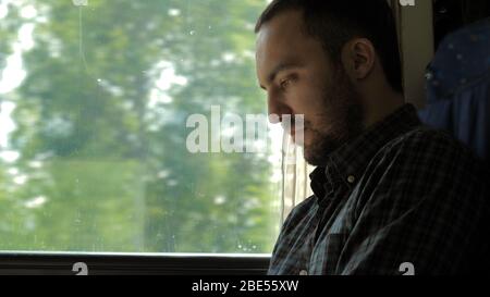 Businessman Commuting On Train Using Digital Tablet. Stock Photo