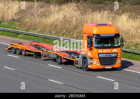 Empty DE Rooy Dutch autotransporter; Haulage delivery trucks, custom-made transport lorry, transportation, orange truck, cargo carrier, DAF CF Tractor unit vehicle, European commercial transport industry, M6 at Manchester, UK Stock Photo