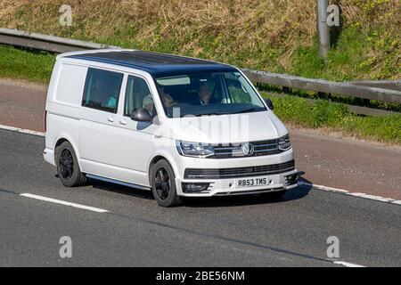 2018 white window van VW Volkswagen Transporter Sportline 2.0 BiTDI T32 BlueMotion Tech Sportline Crew Van DSG; TDI B Vehicular traffic moving vehicles, driving vehicle on UK roads, motors, motoring on the M6 motorway highway Stock Photo