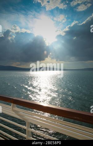 Sunset from the deck of a cruise ship across the ocean, cruising the Baltic Sea. Stock Photo