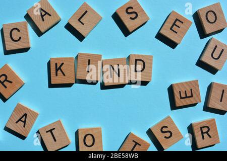 Kind, word surrounded by random alphabet letters on blue Stock Photo