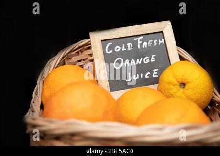 Beautiful big basket with oranges. Close-up Stock Photo