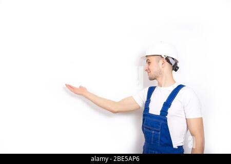 The guy the builder points to the wall. Place for text Stock Photo