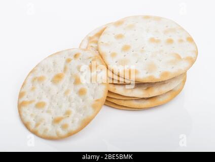 Stack of round organic crispy salty crackers on white background. Stock Photo