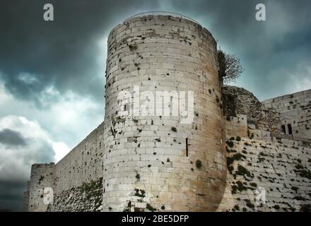 Krak des Chevaliers also called Crac des Chevaliers, Ḥoṣn al-Akrād and formerly Crac de l'Ospital, is a Crusader castle in Syria Stock Photo