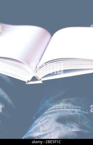 Men's hands hold a white book with clean pages Stock Photo