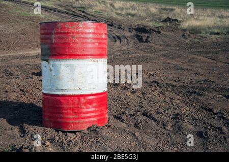 Old metal barrels from under engine oil. Barrels for storing industrial liquids. Industrial waste and pollution. Metal barrels close-up. Stock Photo