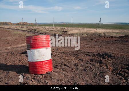 Old metal barrels from under engine oil. Barrels for storing industrial liquids. Industrial waste and pollution. Metal barrels close-up. Stock Photo