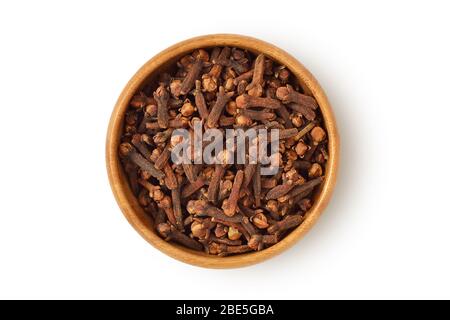 Cloves in wooden bowl on white background Stock Photo