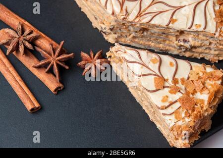 Board with delicious caramel cake on table Stock Photo