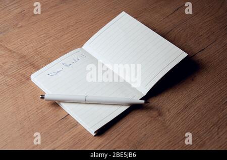 Notebook with pages in a cell. Blank page of open notebook Stock Photo