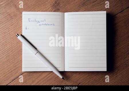 Notebook with pages in a cell. Blank page of open notebook Stock Photo
