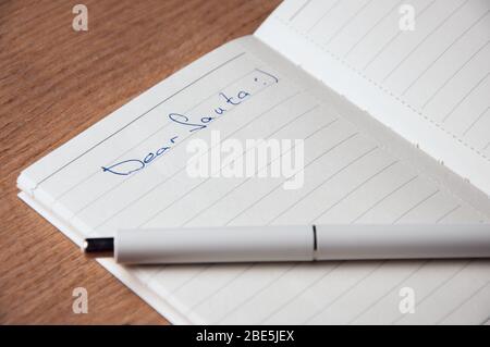 Notebook with pages in a cell. Blank page of open notebook Stock Photo