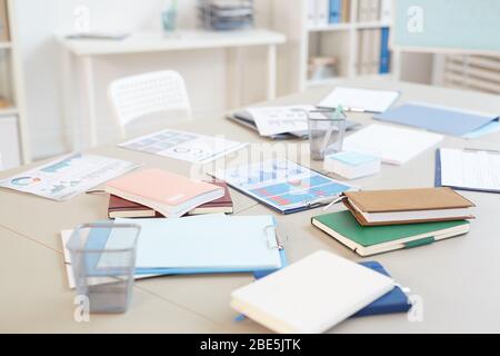 Background image of empty office workplace with documents and charts on white desk, copy space Stock Photo