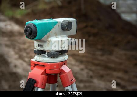 Surveying measuring equipment level theodolite on tripod. Construction measuring tool Stock Photo