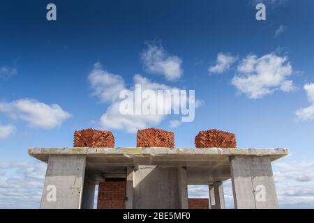 Concrete structure on the roof of a house under construction. Construction of buildings using reinforced concrete structures. Concrete frame with furt Stock Photo