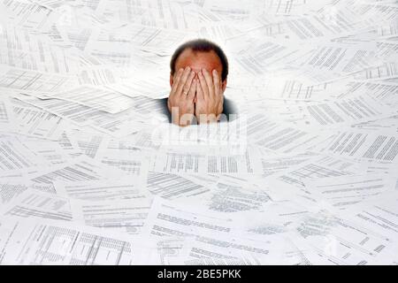 Stress durch zuviel Buerokratie, Mann erstickt in Papier, Insolvenz, Pleite, MR: Yes Stock Photo