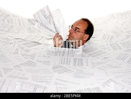Stress durch zuviel Buerokratie, Mann erstickt in Papier, Insolvenz, Pleite, MR: Yes Stock Photo