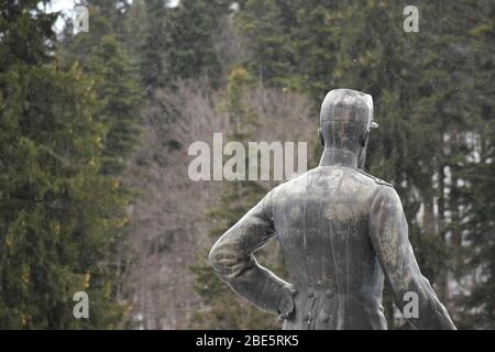 Statue of a man turned around outside Peles Castle Sinaia Stock Photo